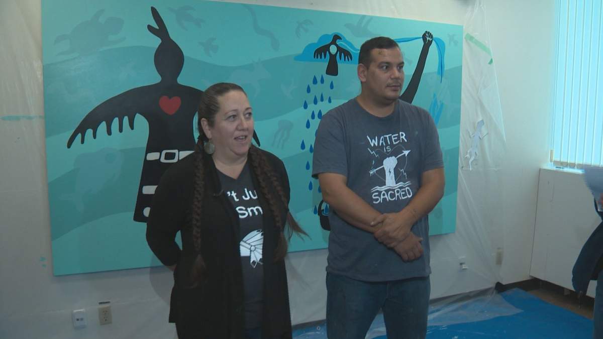 Artists Christi Belcourt and Isaac Murdoch in front of their painting at MacEwan University’s kihêw waciston Indigenous Centre in Edmonton, Alta. October 30, 2018.