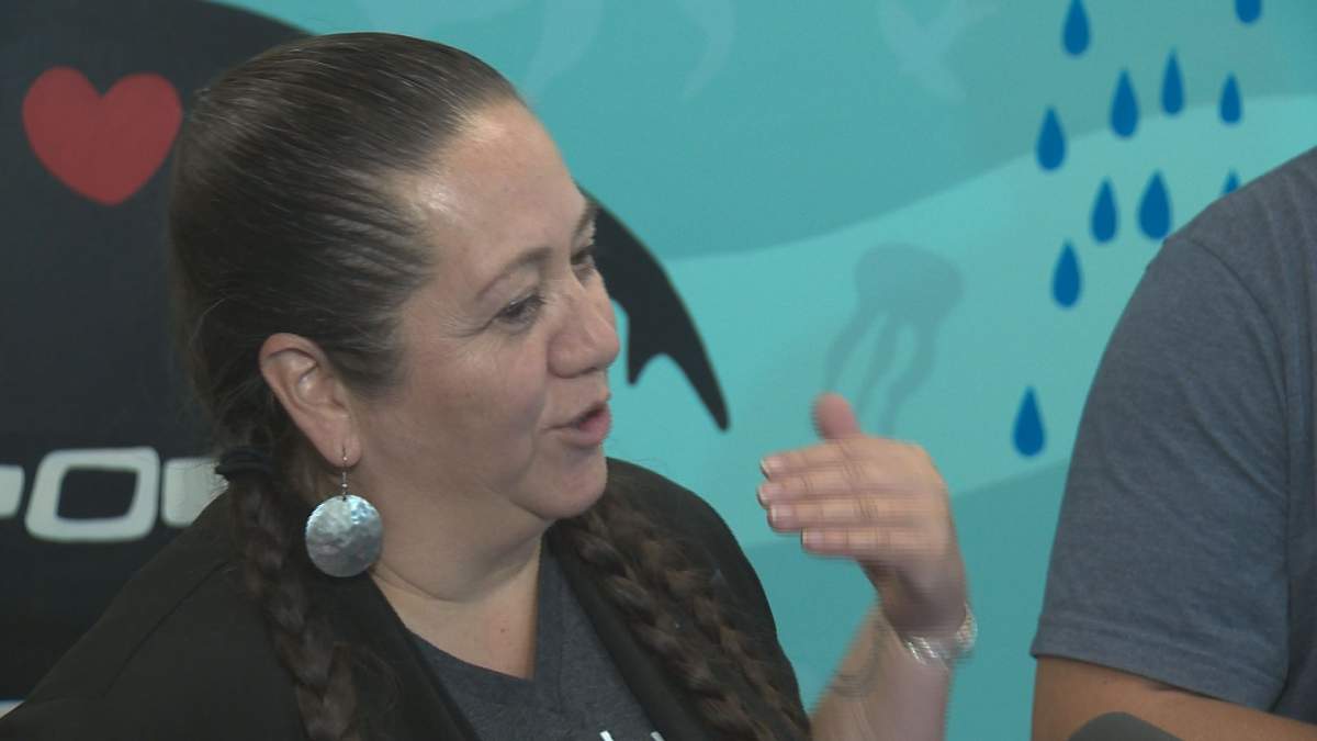 Artists Christi Belcourt in front of the painting at MacEwan University’s kihêw waciston Indigenous Centre in Edmonton, Alta. October 30, 2018.