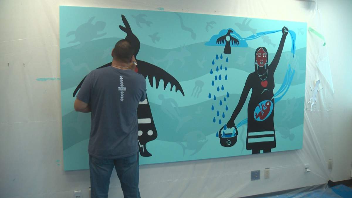 Artists Christi Belcourt and Isaac Murdoch working on their painting at MacEwan University’s kihêw waciston Indigenous Centre in Edmonton, Alta. October 30, 2018.