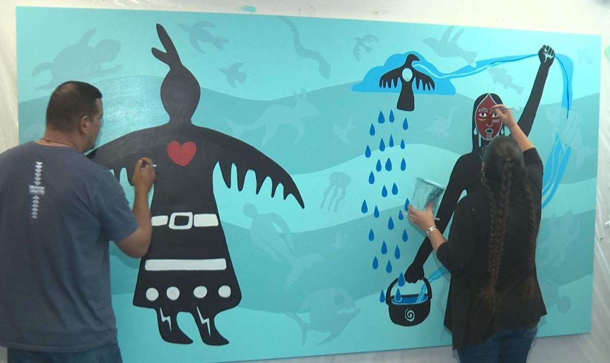 Artists Christi Belcourt and Isaac Murdoch working on their painting at MacEwan University's kihêw waciston Indigenous Centre in Edmonton, Alta. October 30, 2018. 