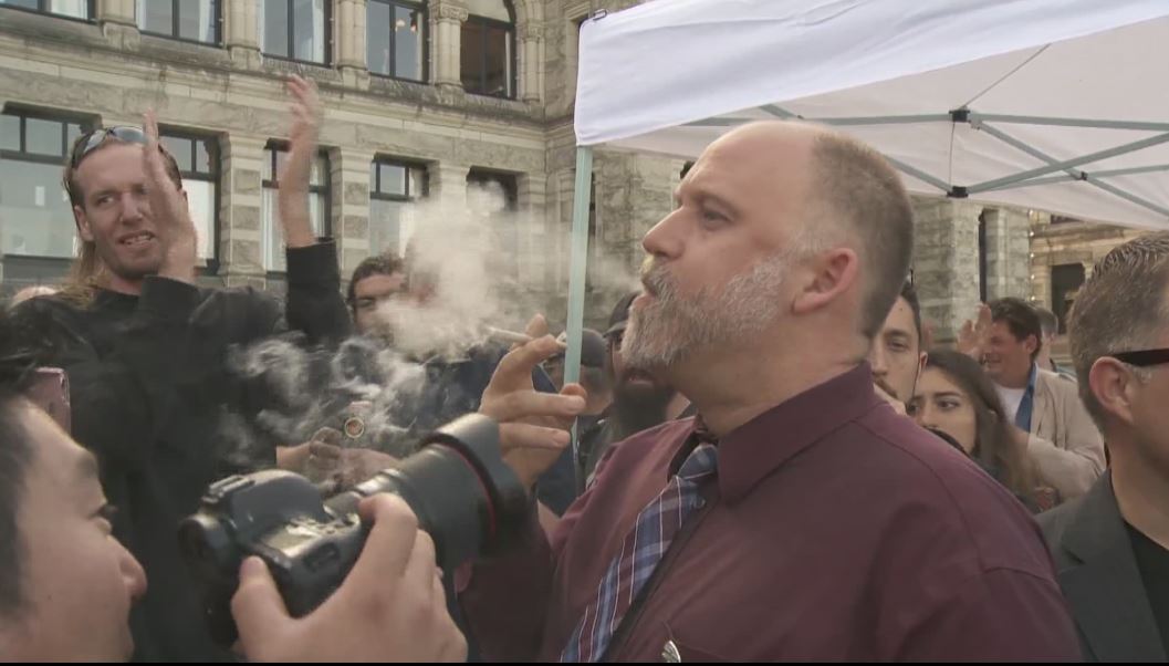 Marijuana activist Dana Larsen blows out a puff of smoke at the B.C. Legislature. 