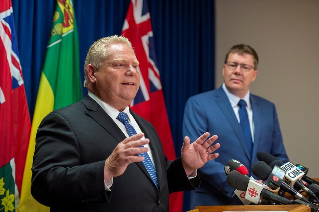 Premier of Ontario Doug Ford, left, speaks as Premier of Saskatchewan Scott Moe listens during a media event in Saskatoon, Thursday, October 4, 2018.