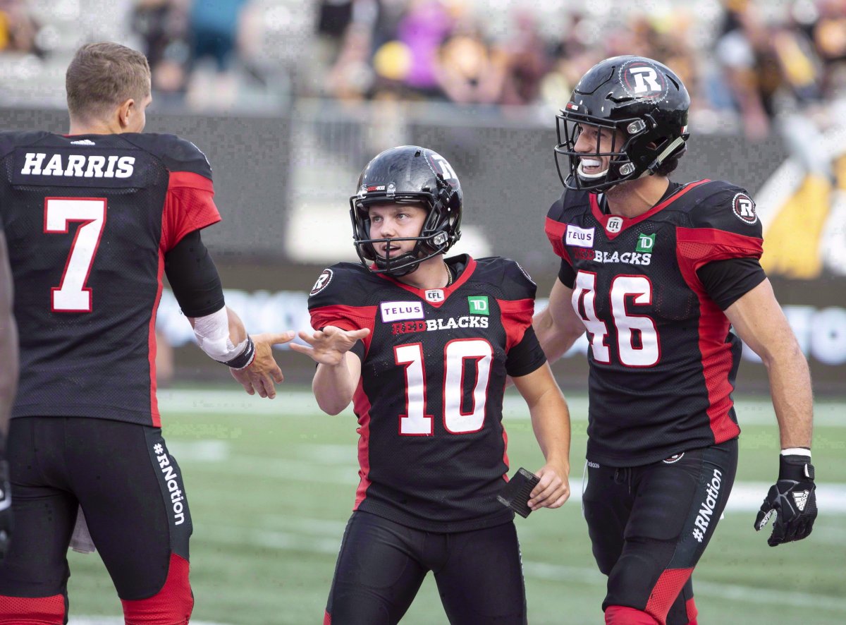 Ottawa Redblacks kicker Lewis Ward celebrates with quarterback Trevor Harris during second half CFL football game action against the Hamilton Tiger-Cats in Hamilton, Ont., on Saturday, July 28, 2018. Ward always believed he could succeed in the CFL, but the Ottawa Redblacks rookie kicker admits he's exceeding even his own lofty expectations.