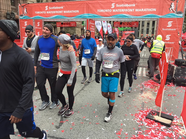 Runners can be seen running through the finish line at the Toronto Scotiabank Waterfront Marathon Sunday morning. 