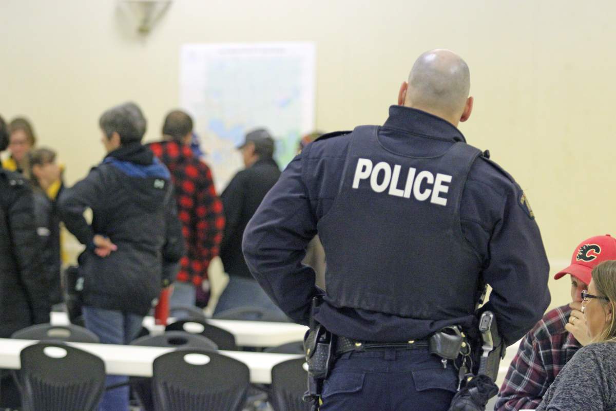 Lac La Biche RCMP Const. Max Bedard speaks with community search organizer Carole Torresan and her husband Dean, as the search plan gets underway at the Hylo Hall, near Lac La Biche, Alta. on Saturday, October 13, 2018.