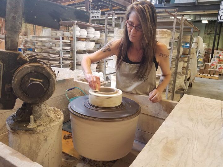 Artist Lisa Miklash presses a more than century-old jigger machine into a lump of clay at the Medalta Potteries Factory, which is part of the Historic Clay District in Medicine Hat, Alta. on Thursday June 21, 2018. The old factory serves as a museum, artists' workspace, archaeological site and cultural hub. 