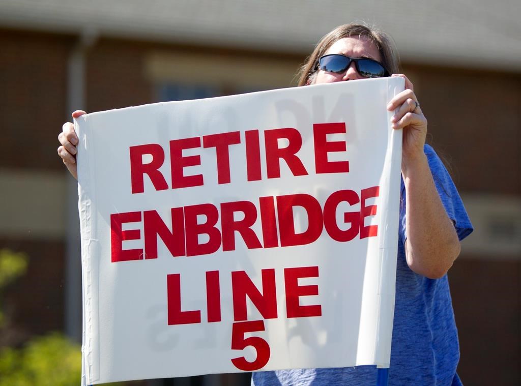 In this July 6, 2017, file photo, Lauren Sargent, takes part in a protest before the Enbridge Line 5 pipeline public information session in Holt, Mich.