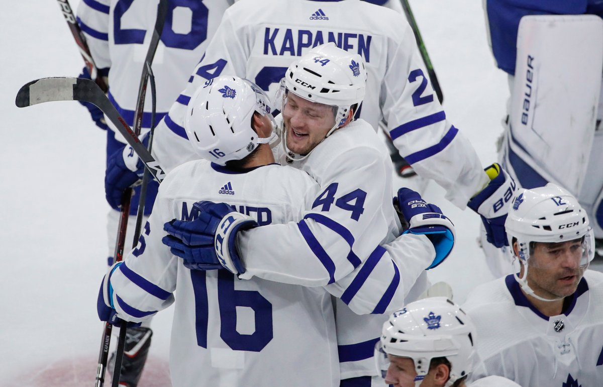 Toronto Maple Leafs defenceman Morgan Rielly (44) celebrates with centre Mitchell Marner (16) after scoring in overtime of an NHL hockey game against the Chicago Blackhawks on Sunday, Oct. 7, 2018, in Chicago. 