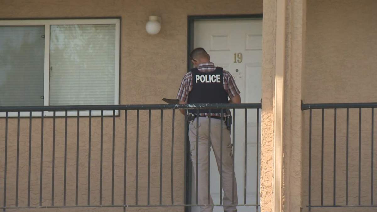 A police officer at the Sundance Suites apartment building in Vernon.