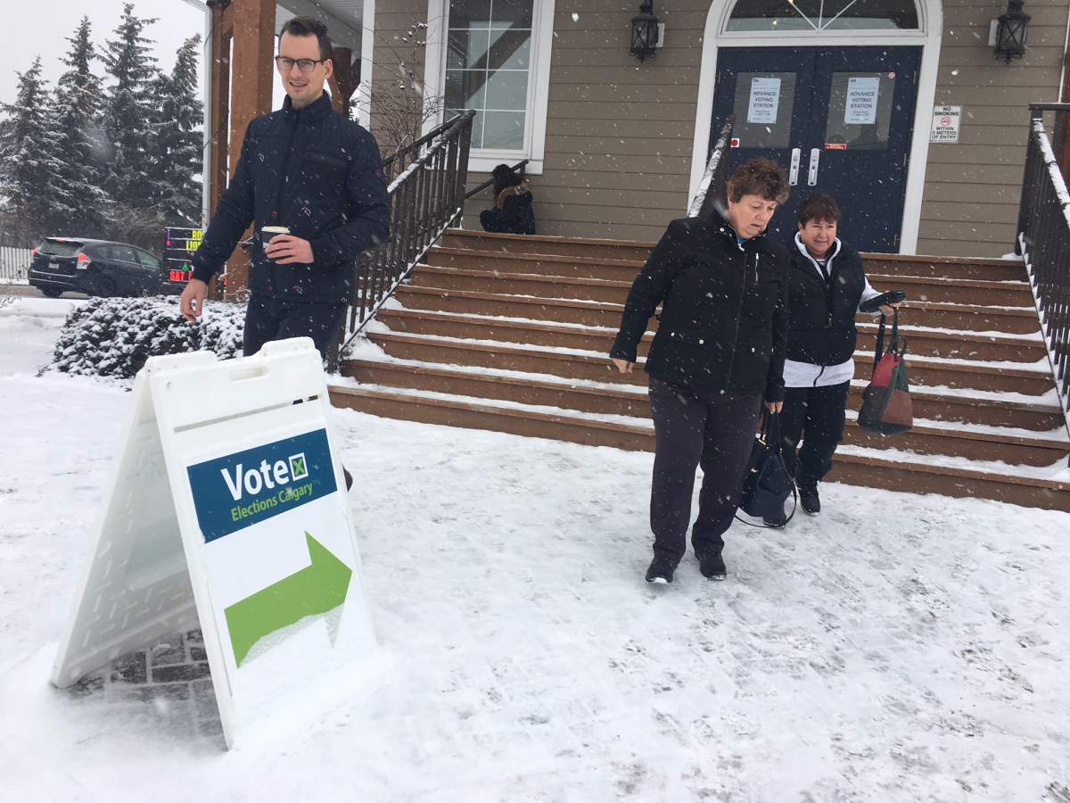 People exit a polling station in Calgary, Alta. during the advance voting for the 2026 Olympic bid plebiscite on Nov. 6, 2018.