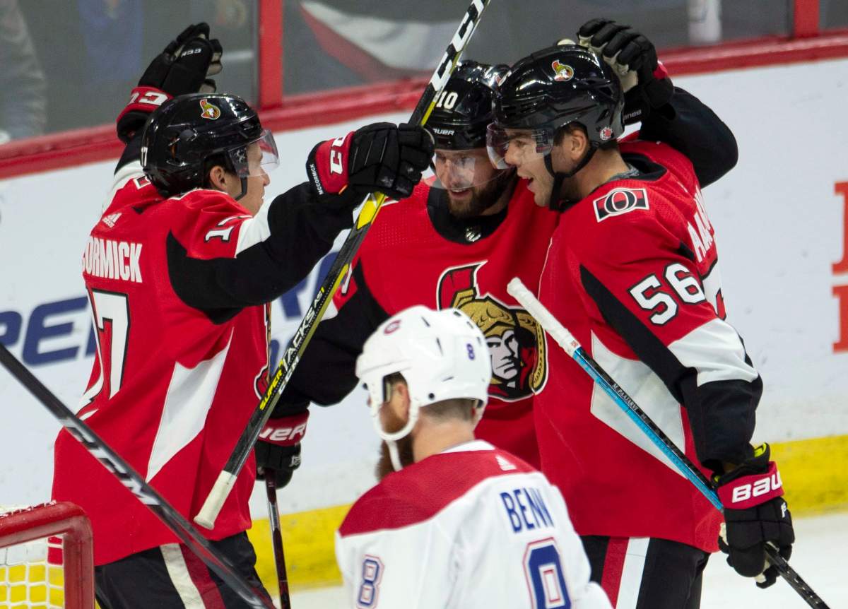 Montreal Canadiens defenceman Jordie Benn skates past Ottawa Senators left wing Tom Pyatt (centre) as he celebrates his goal with Magnus Paajarvi (right) and Max McCormick during first period NHL pre-season action Saturday September 29, 2018 in Ottawa. For the Senators it's all about the future. After finishing second last in the league last season Senators ownership and management decided to move ahead with a full rebuild.