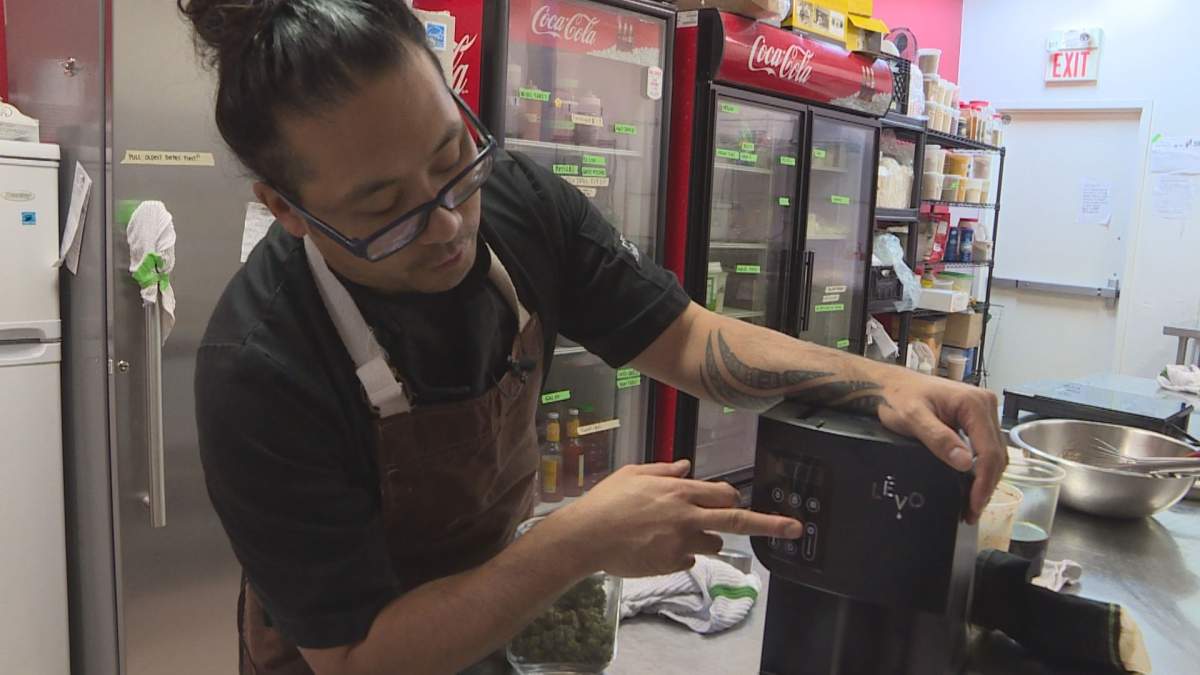 Pineda shows off one of the machines he uses to make cannabis oil.