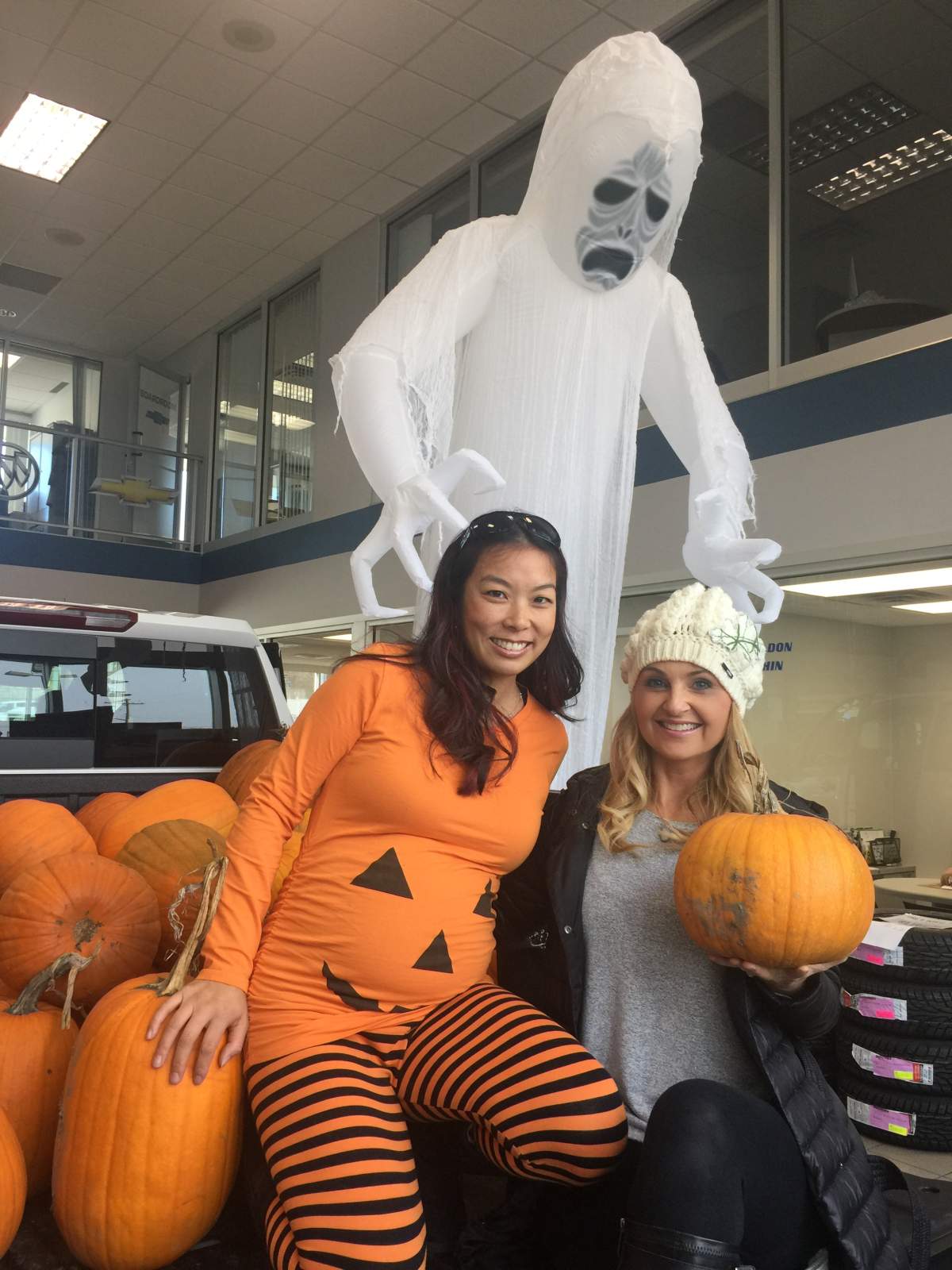 Silver Star\’s Wesla Wong and Global Okanagan\’s Klaudia Van Emmerik hand out free pumpkins in exchange for donations for the BC SPCA.