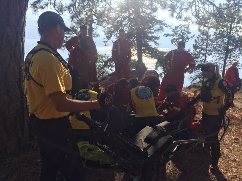 Rescuers from Central Okanagan Search and Rescue attend to an injured hiker on Pincushion Mountain in Peachland, BC, Oct. 20, 2018.