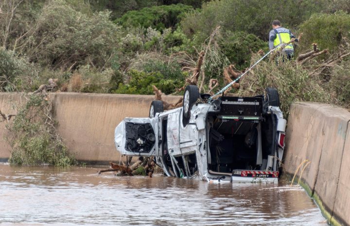 A policeman searches for victims near of the beach of Sillot, in Mallorca island, eastern Spain, 10 October 2018, a day after the flash floods caused by heavy rainfall hitting the island.