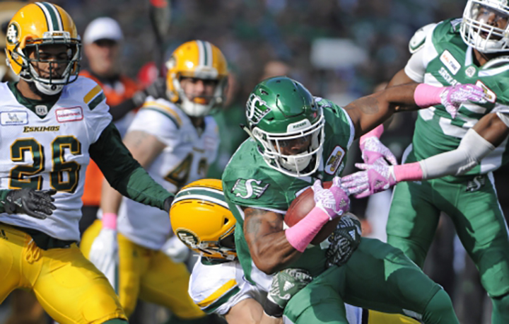 Saskatchewan Roughriders running back Marcus Thigpen battles through a crowd during first half CFL action against the Edmonton Eskimos, in Regina on Monday, Oct. 8, 2018.
