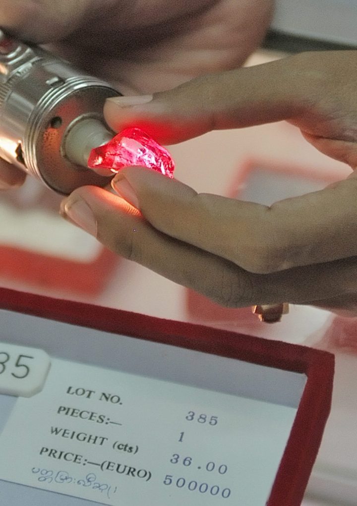 A staff member from the state-run Myanmar Gems Enterprise displays a 36-carat ruby with a price tag of half a million euros on display at the Gems Emporium in Yangon, Myanmar, in this Oct. 19, 2006, file photo.