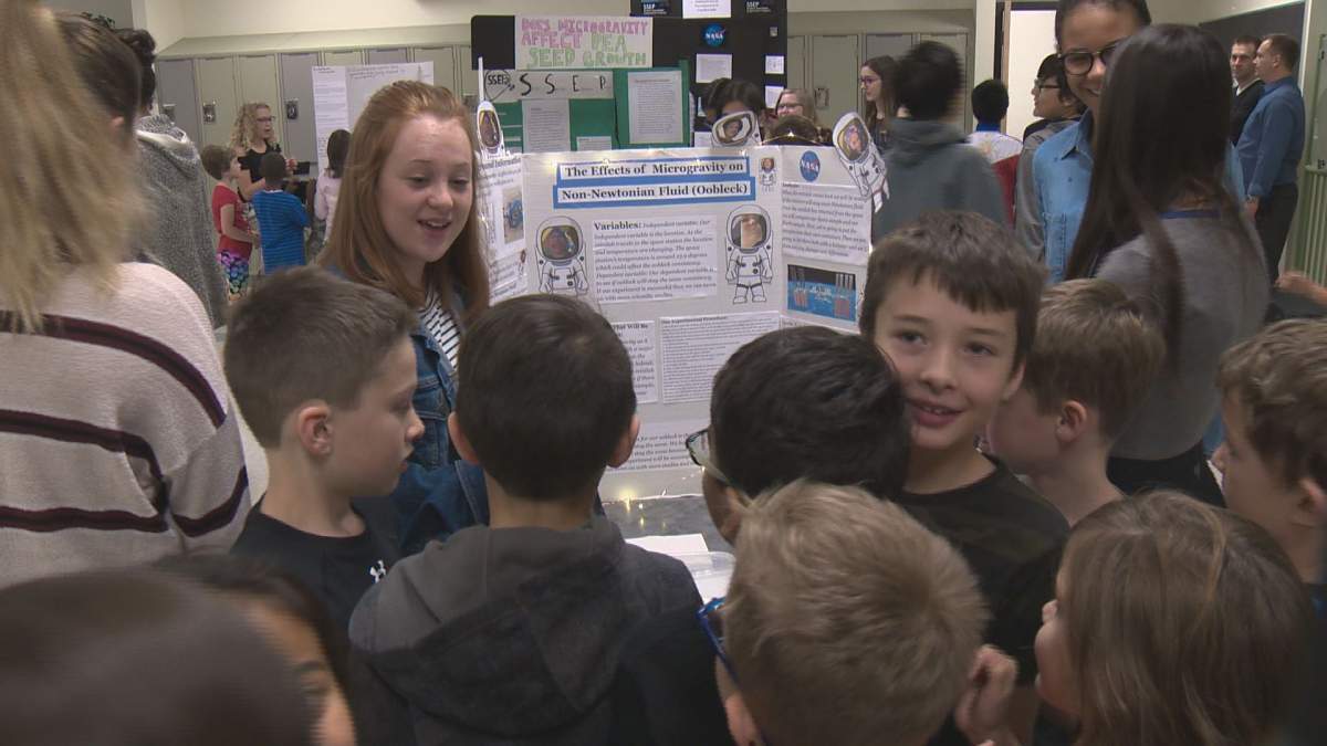Students at Michael Strembitsky School in Edmonton show off their science experiments.