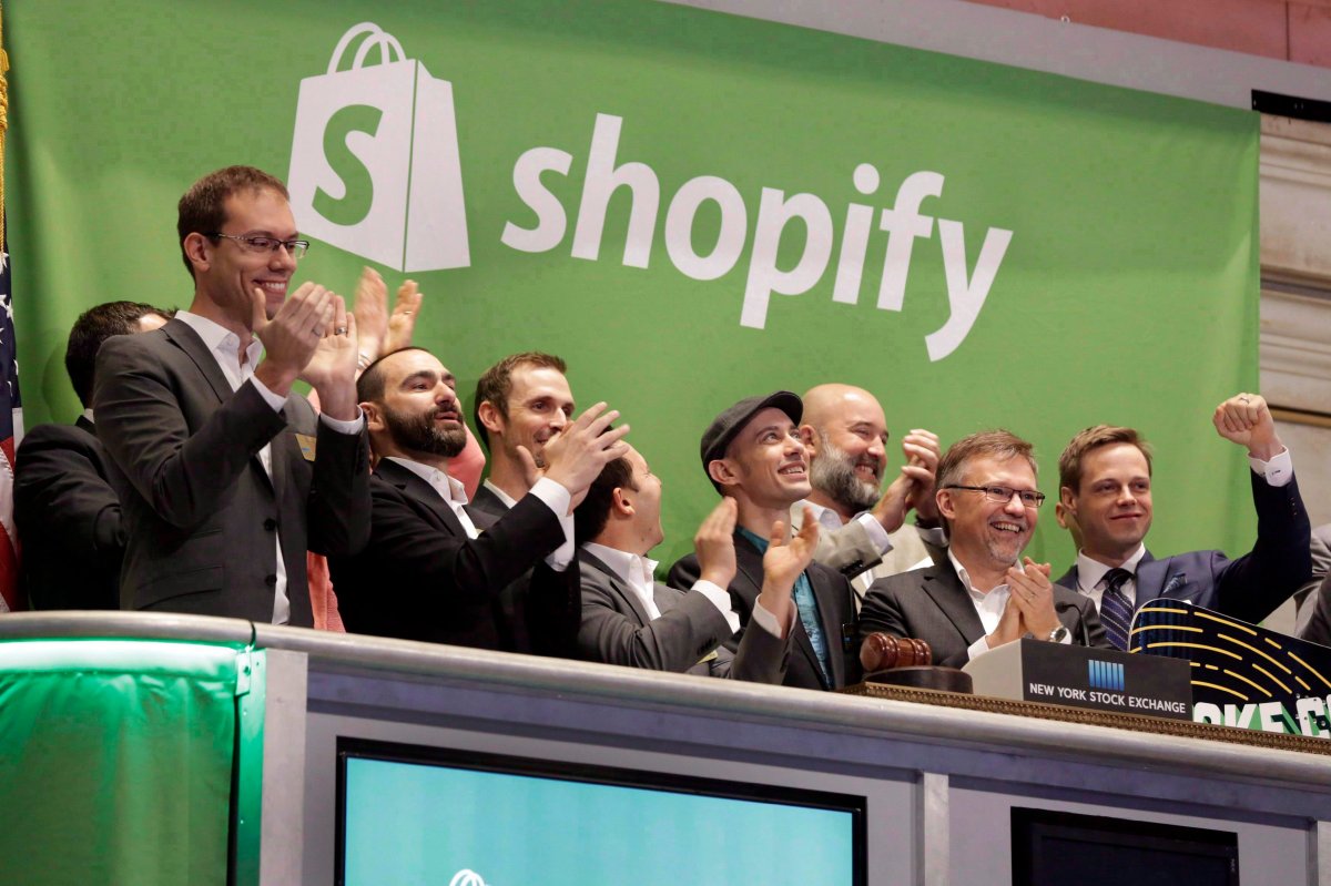 Shopify CEO Tobias Lutke, center wearing hat, is celebrated as he rings the New York Stock Exchange opening bell, marking the Canadian company's IPO on May 21, 2015. Shopify Inc. reported a loss of US$23.2 million in its latest quarter as its revenue grew 58 per cent compared with a year ago.