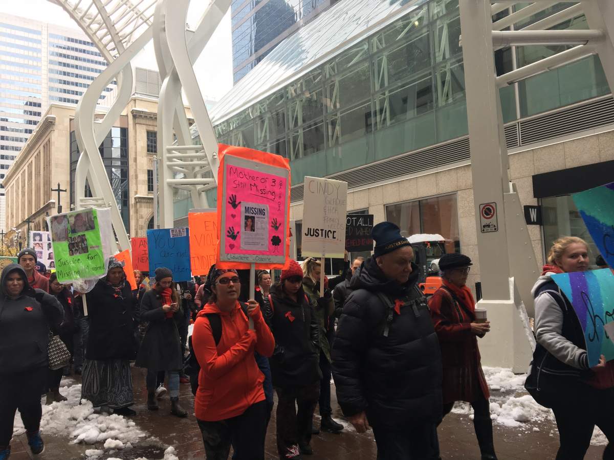 Marchers walk from Stephen Avenue to Olympic Plaza