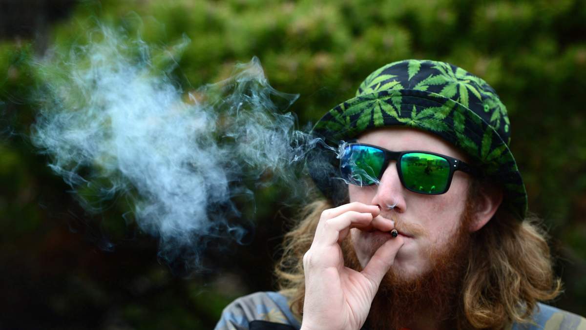 A man smokes during a 4/20 rally on Parliament Hill in Ottawa, on Thursday, April 20, 2017. 