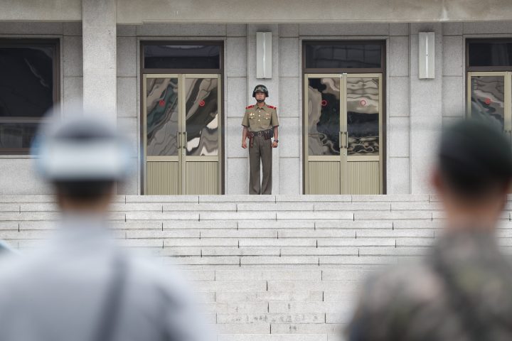 In this file photo, a North Korean soldier, centre, and South Korean soldiers face each other at the Joint Security Area in the border village Panmunjom, South Korea.
