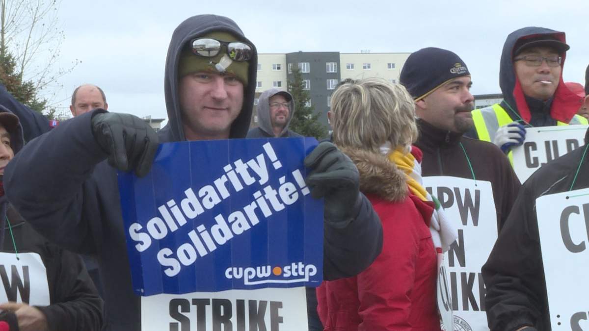 Canada Post workers during a rotating strike Monday.