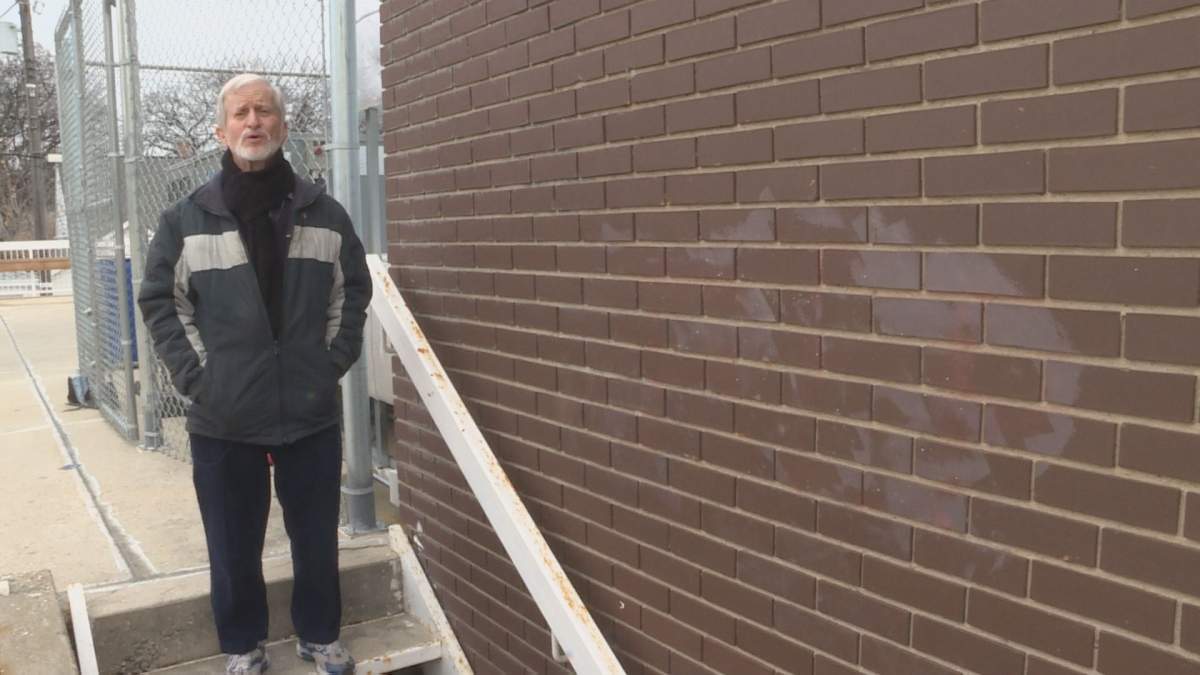 Philip Spevack stands where graffiti was written on the side of the Temple Shalom.