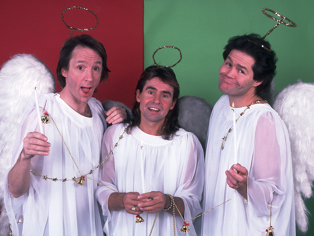 The Monkees pose for their Christmas card at the Athletic & Convocation Center in South Bend, Indiana on November 11, 1986.