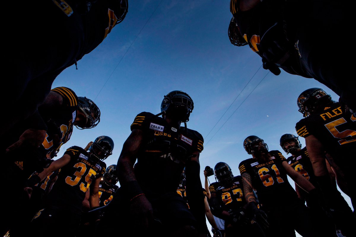 Hamilton Tiger-Cats players huddle before first half CFL football action against the Saskatchewan Roughriders, in Hamilton, Ont., Thursday July 19, 2018.