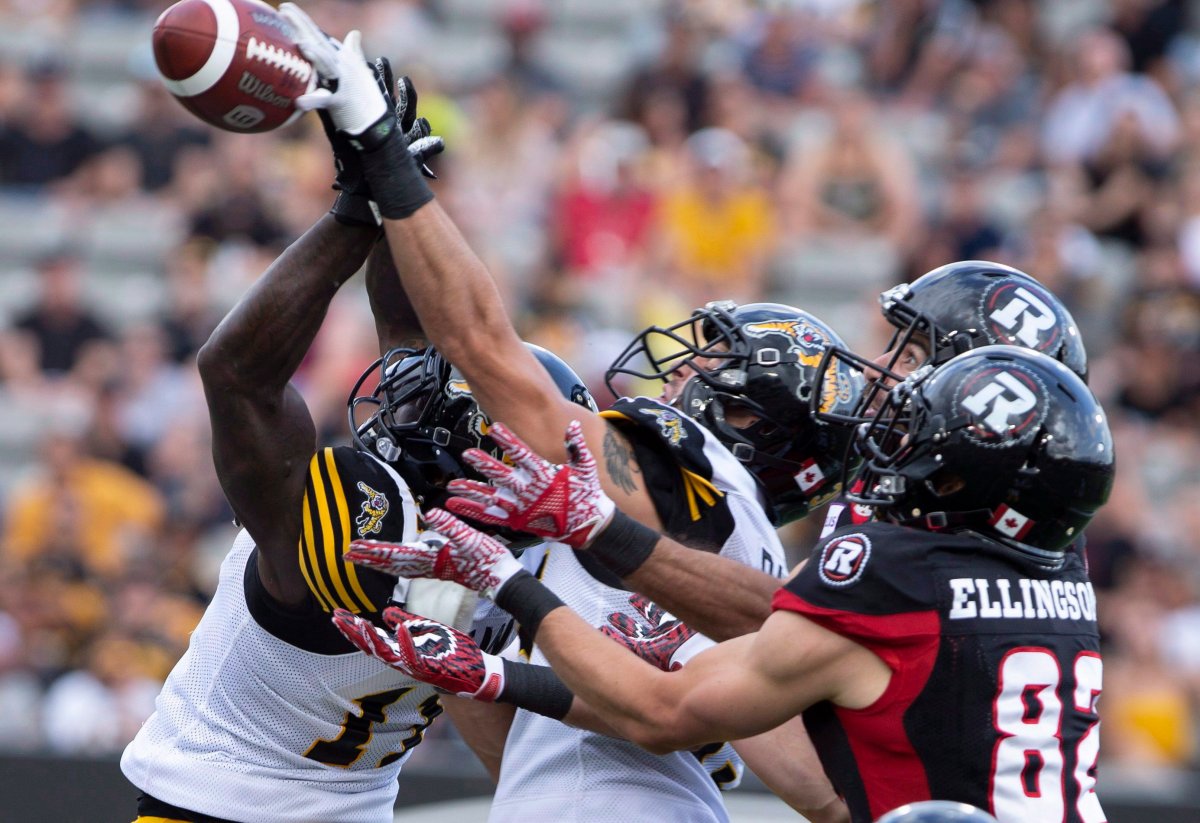 Hamilton Tiger-Cats and Ottawa Redblacks players battle for a pass that was thrown by the Ottawa Redblacks at the end of the first half CFL football game action in Hamilton, Ont. on Saturday, July 28, 2018.