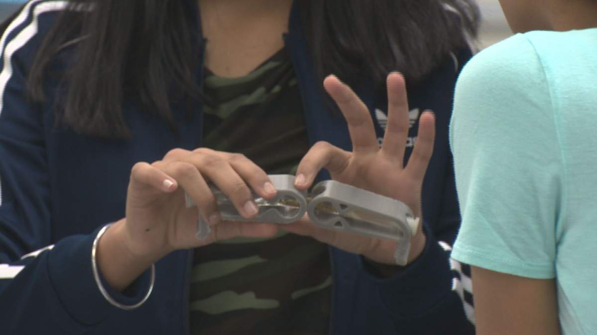 Students at Michael Strembitsky School in Edmonton show off their science experiments.