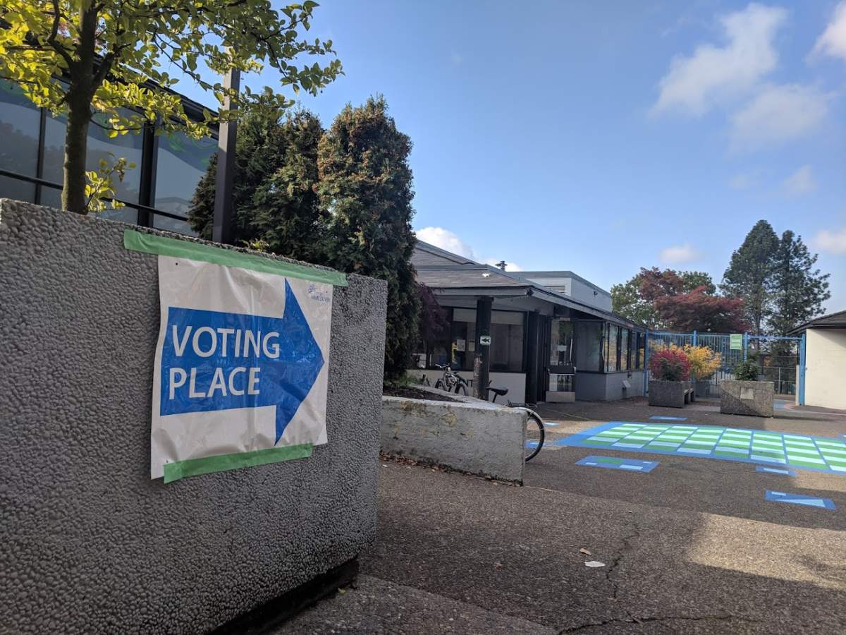 A sign points the way to a voting place in Vancouver.
