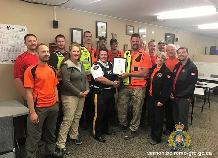 Vernon North Okanagan RCMP superintendent Shawna Baher presents Vernon Search and Rescue personnel with a certificate of appreciation. .
