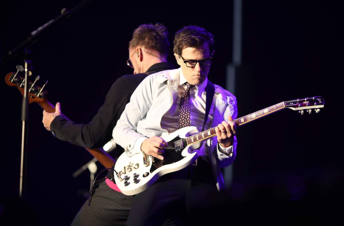 Scott Shriner (L) and Rivers Cuomo of Weezer perform during KROQ Almost Acoustic Christmas 2017 at The Forum on Dec. 10, 2017, in Inglewood, Calif.