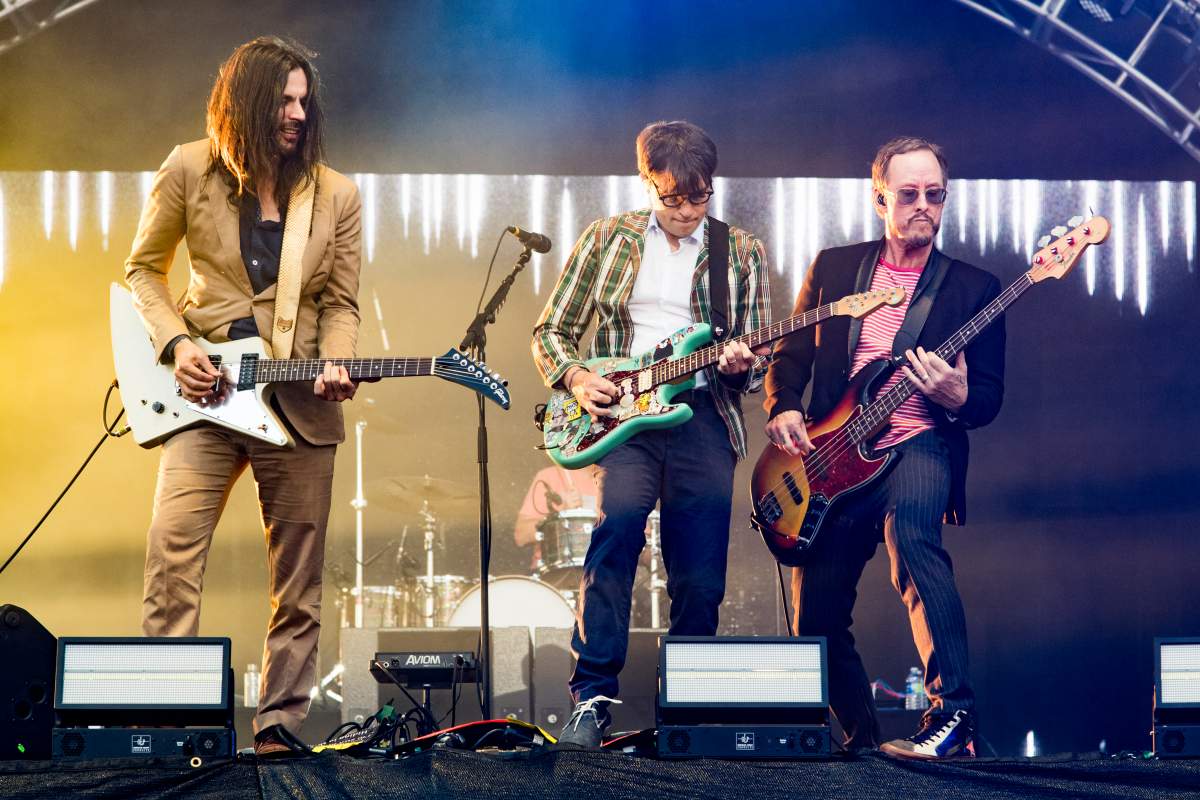 (L-R) Brian Bell, Rivers Cuomo and Scott Shriner of Weezer perform at the Del Mar Fairgrounds on Sept. 15, 2017, in Del Mar, Calif.