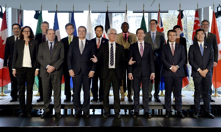 Canada's Minister of International Trade Diversification Jim Carr speaks as delegates pose for a family photo at the Ottawa Ministerial on WTO Reform, in Ottawa on Thursday, Oct. 25, 2018. 