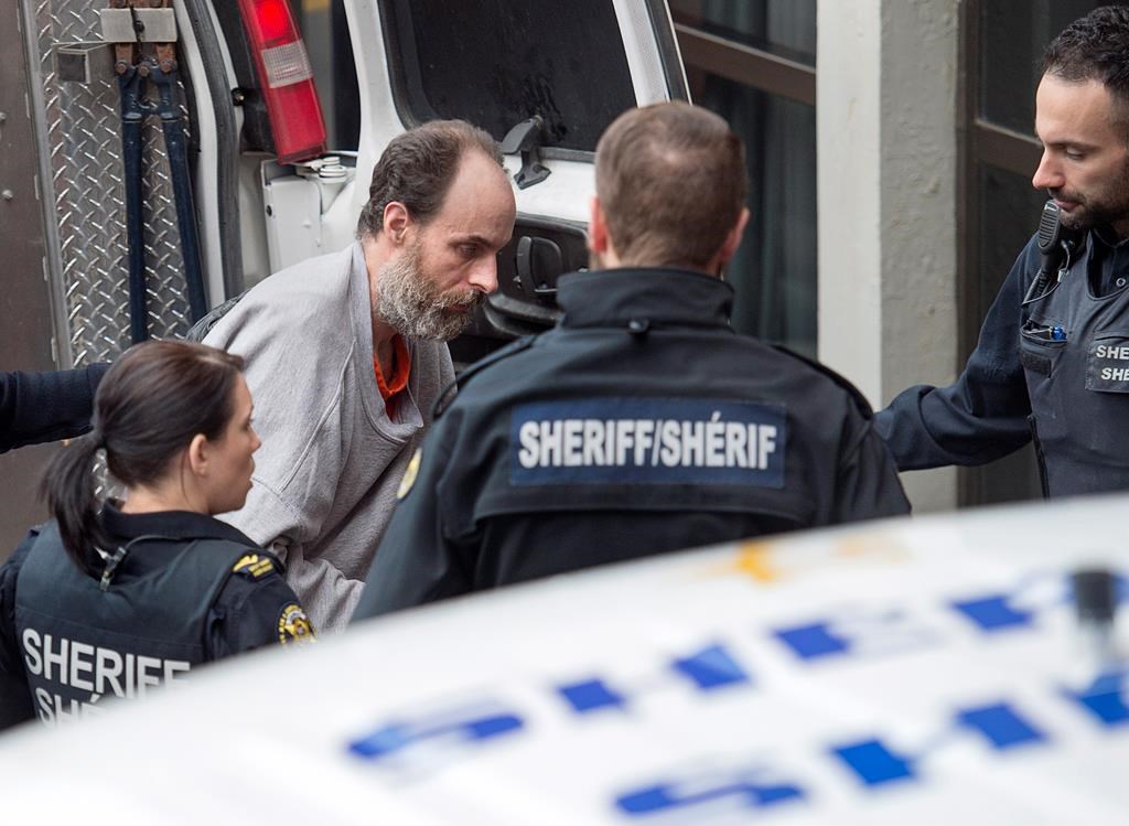 Matthew Vincent Raymond, charged with four counts of first degree murder, arrives at provincial court in Fredericton on Monday, Oct. 29, 2018. Two city police officers were among four people who died in a shooting in a residential area on the city's north side. THE CANADIAN PRESS/Andrew Vaughan.