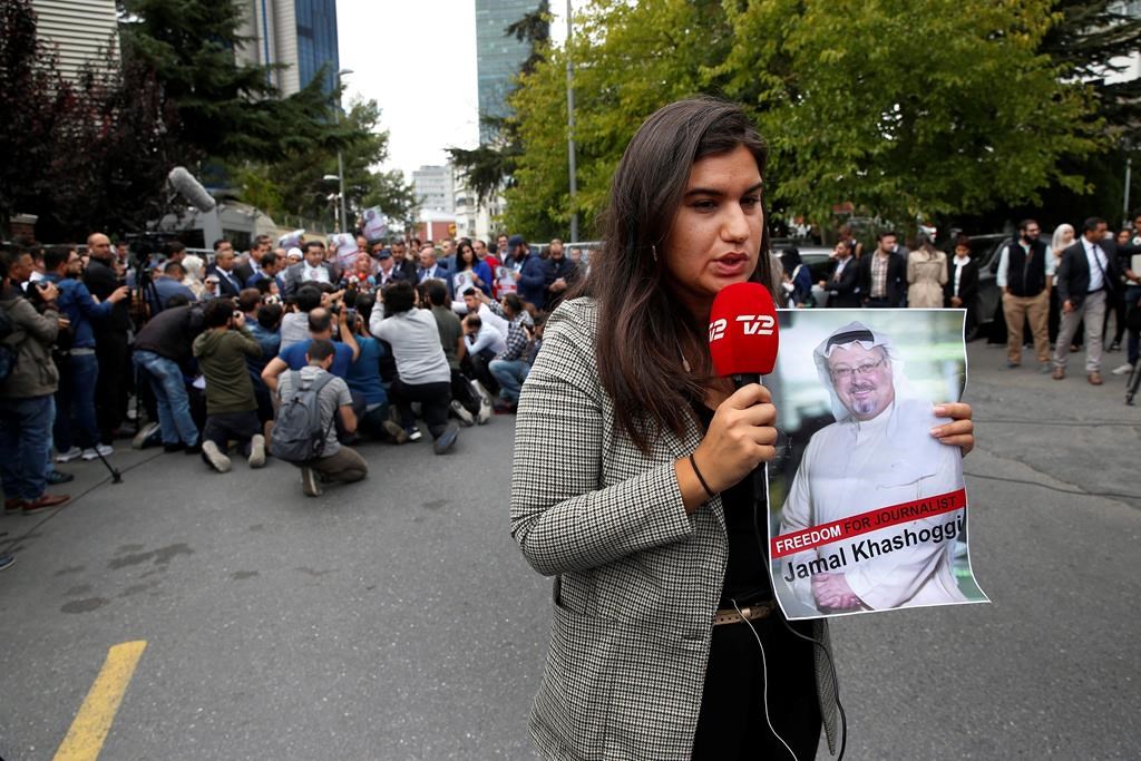 A journalist holding a poster of missing Saudi writer Jamal Khashoggi, near the Saudi Arabia consulate in Istanbul, Monday, Oct. 8, 2018. Khashoggi, 59, went missing on Oct. 2 while on a visit to the consulate in Istanbul for paperwork to marry his Turkish fiancee. The consulate insists the writer left its premises, contradicting Turkish officials.