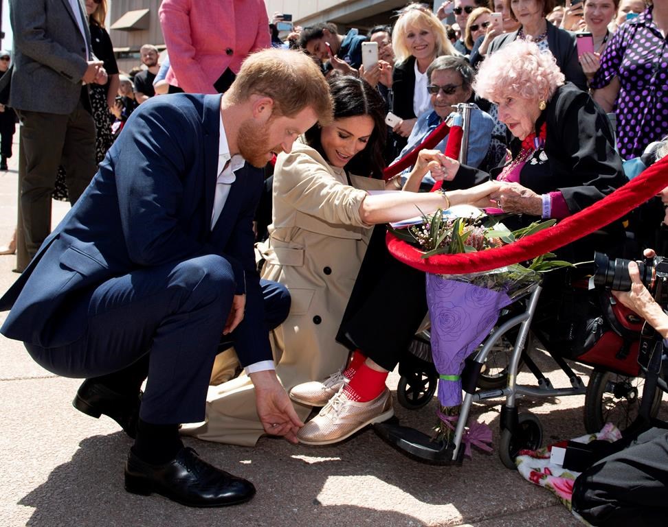 Prince Harry and Meghan, Duchess of Sussex meet 98-year-old Daphne Dunne during a walkabout outside the Opera House in Sydney, Australia, Tuesday, Oct. 16, 2018. (Paul Edwards/Pool via AP)