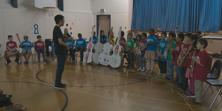 After learning music basics and proper instrument care with plastic and cardboard versions, 20 students graduated to the real thing on Tuesday.