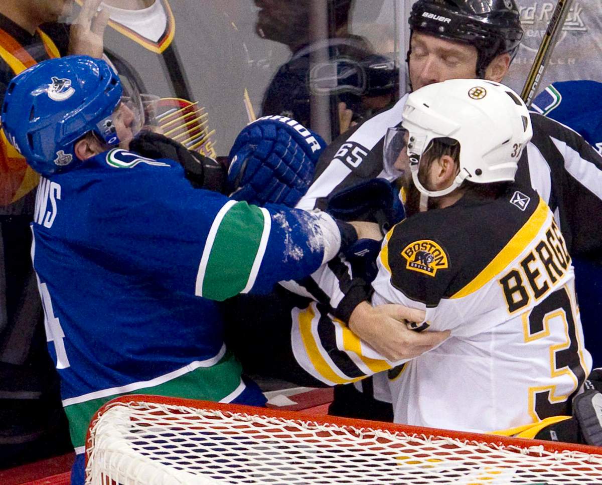 Vancouver Canucks left wing Alex Burrows, left, skirmishes with Boston Bruins center Patrice Bergeron after the first period of game one Stanley Cup final playoffs in Vancouver, B.C., Wednesday, June 1, 2011. Burrows was not suspended for allegedly biting the finger of Patrice Bergeron.