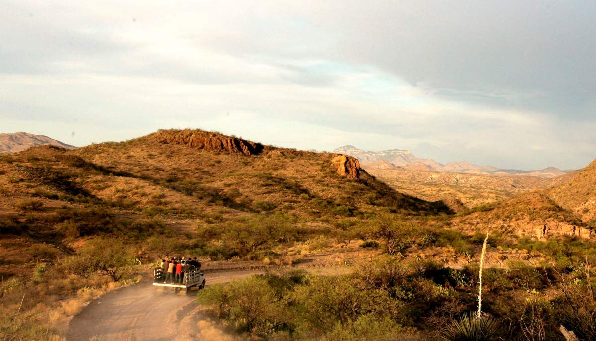 A group of men travel along a border road outside of Sasabe, Mexico, Wednesday, May 17, 2006, en route to a drop-off spot where they begin the trek on foot to cross illegally into the United States near Arivaca, Ariz.