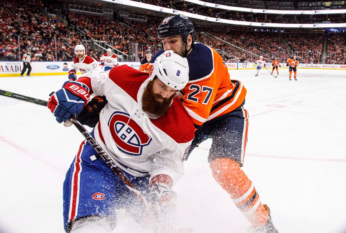 Montreal Canadiens Jordie Benn (8) and Edmonton Oilers' Milan Lucic (27) battle for the puck during second period NHL action in Edmonton, Alta., on Saturday, December 23, 2017. THE CANADIAN PRESS/Jason Franson.