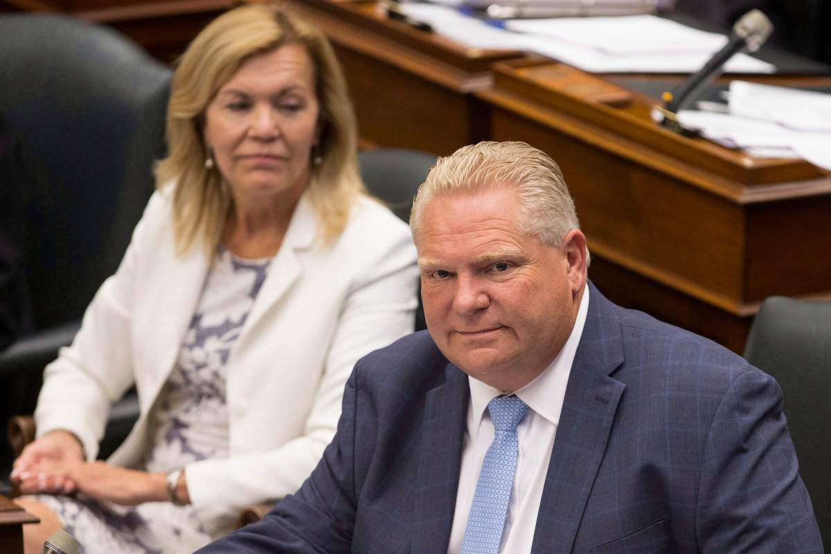 Ontario Premier Doug Ford, right, sits next to PC MPP Christine Elliott during Question Period at Queen's Park, in Toronto on Tuesday, July 31, 2018. 