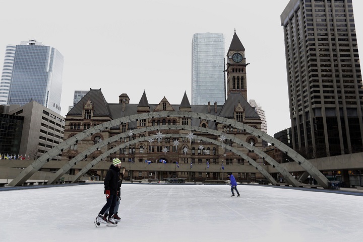 The Globe and Mail reporter Marcus Gee (blue Jacket) tries out the rink at Nathan Phillips square in downtown Toronto on January 15, 2014. 