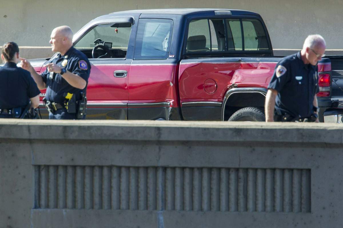 A damaged pickup truck sits on northbound U.S. 131 after a police-involved shooting on the S-Curve in Grand Rapids, Mich., on Thursday, Sept. 27, 2018.