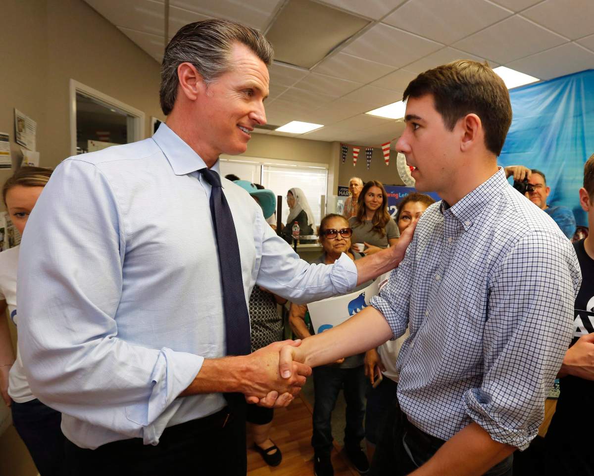 In this Sept. 12, 2018 file photo California gubernatorial candidate. Lt. Gov. Gavin Newsom, left, a Democrat, talks with Democratic Congressional candidate, Josh Harder, during a campaign stop in Modesto, Calif.