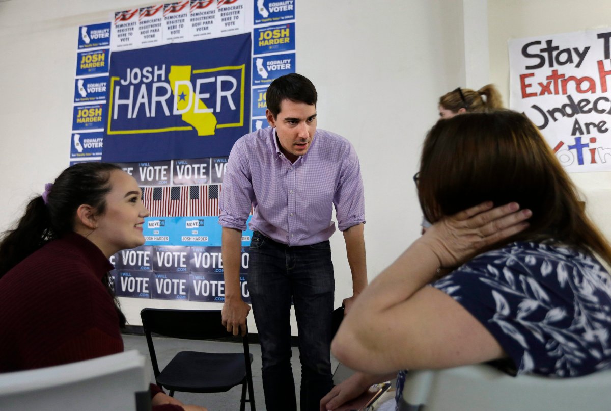 In this photo taken Thursday, Oct. 25, 2018, Josh Harder the Democratic candidate for the California 10th Congressional District, talks with supporters Rebecca, left, and Michelle Tennell, right, in Modesto, Calif. 