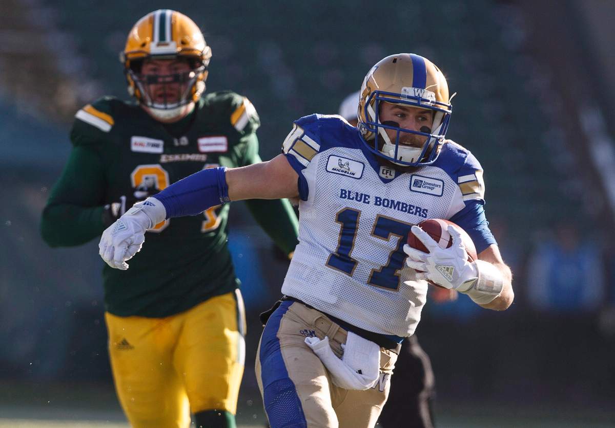 Winnipeg Blue Bombers quarterback Chris Streveler (17) runs the ball as Edmonton Eskimos Calvin McCarty (31) chases during first half CFL action between the Bombers and Eskimos.